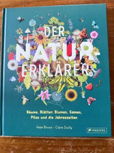 Dunkelrot Der Natur-Erklärer. Das Cover ist bunt und zeigt Motive der Natur